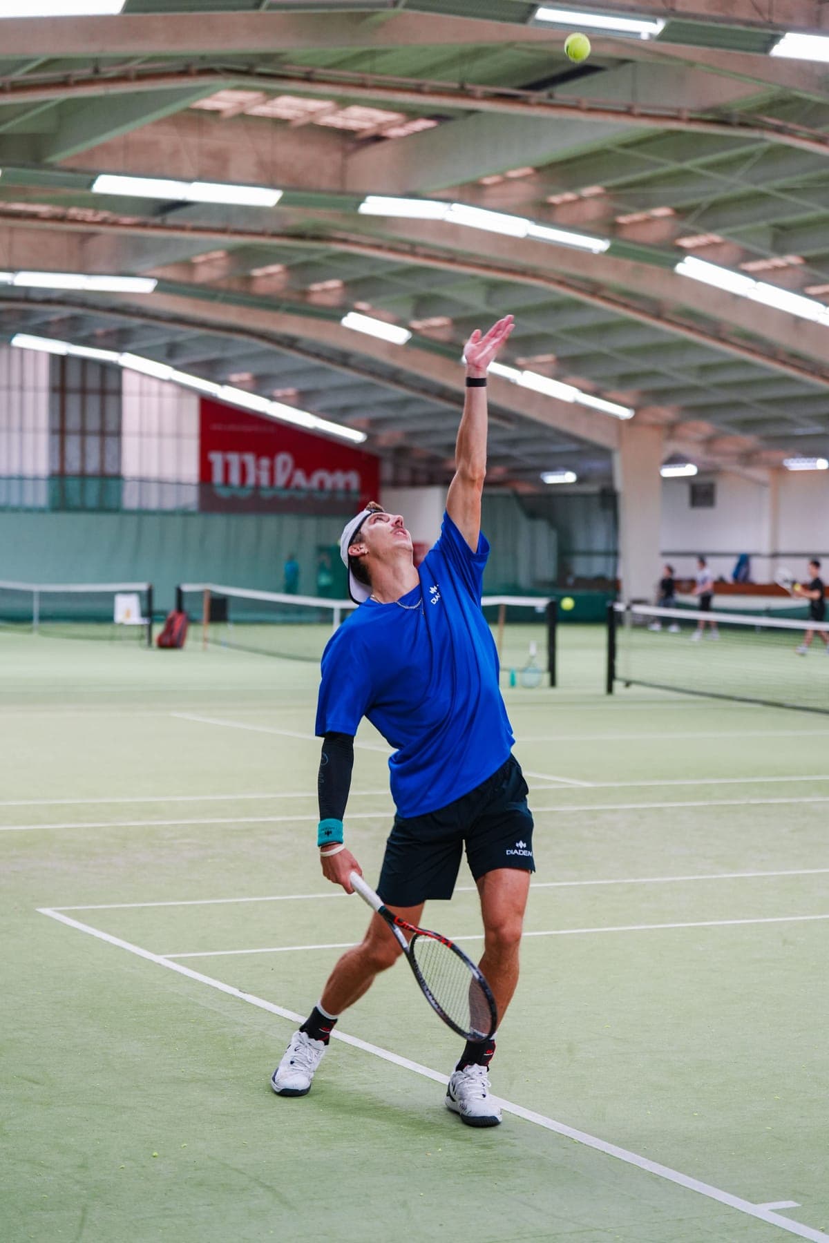 Anton Shepp tossing the ball up to serve