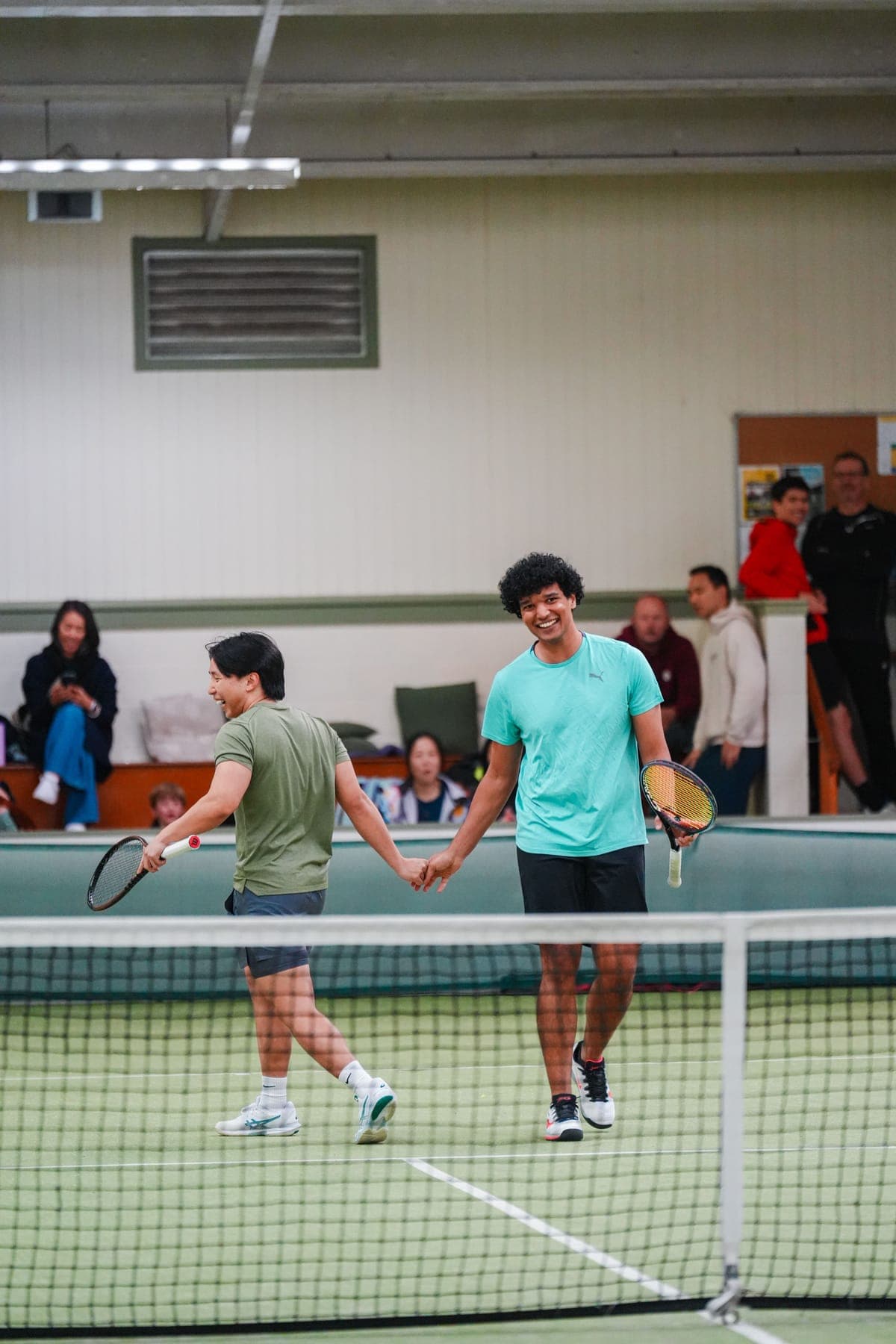 Two challengers walking up to the net, all smiles