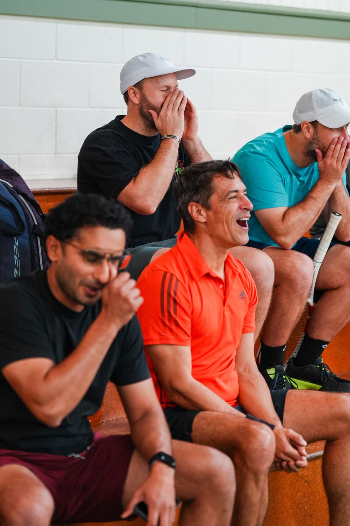 Spectators on the bench laughing and cheering