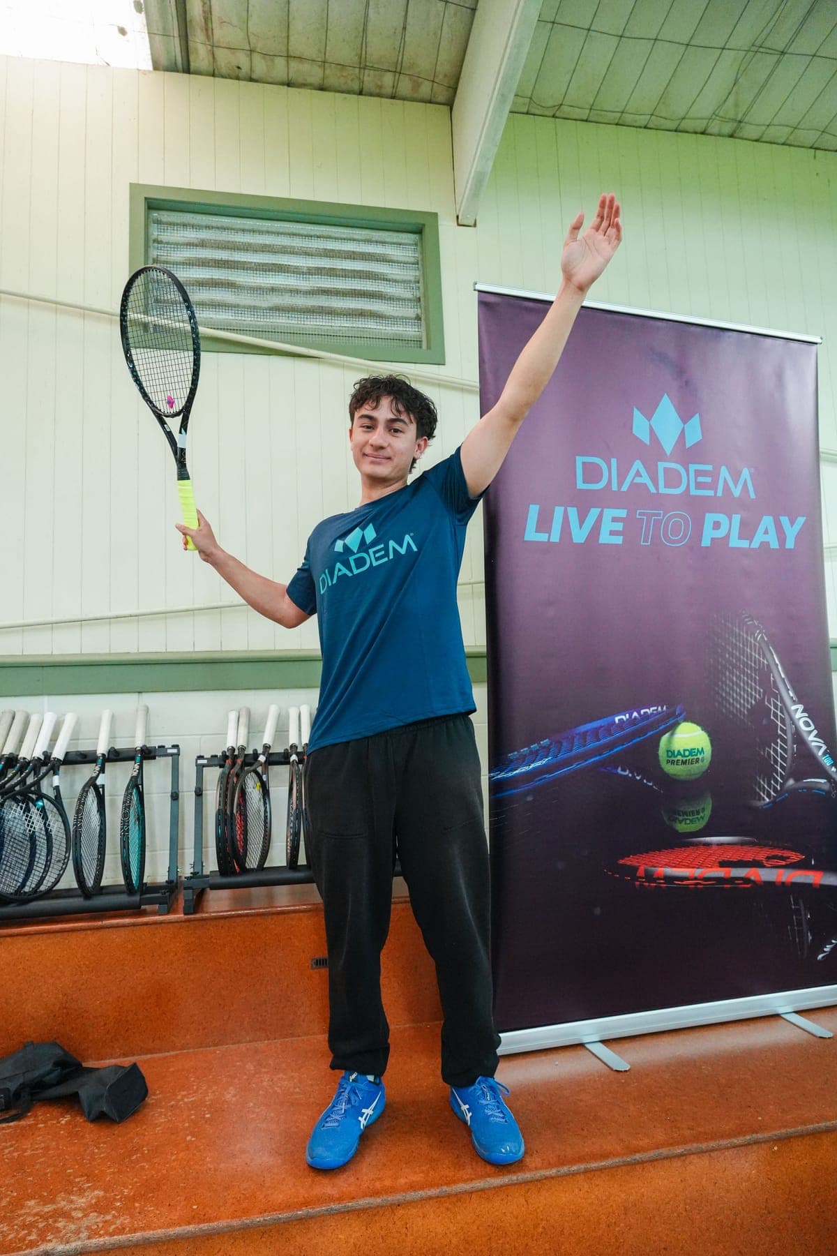 A Diadem hitting partner posing by the Diadem banner