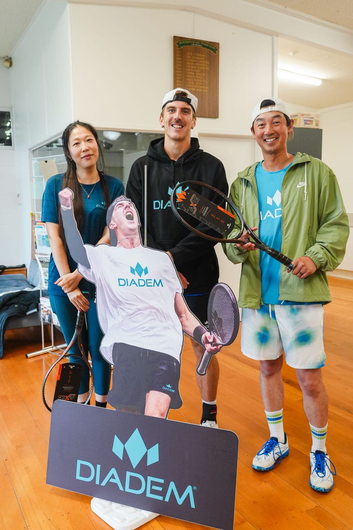 Anton posing with two fans beside a Diadem cut-out