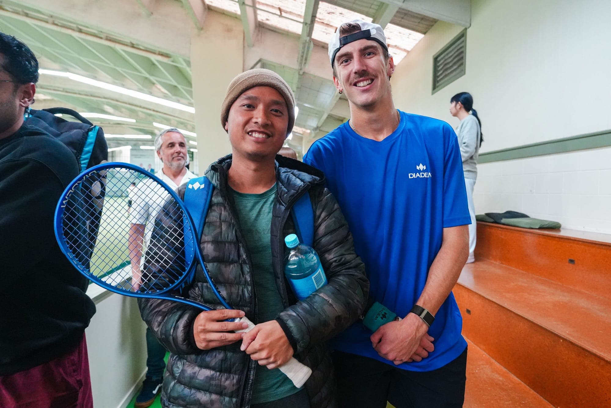 Anton posing with a fan holding a Diadem racket