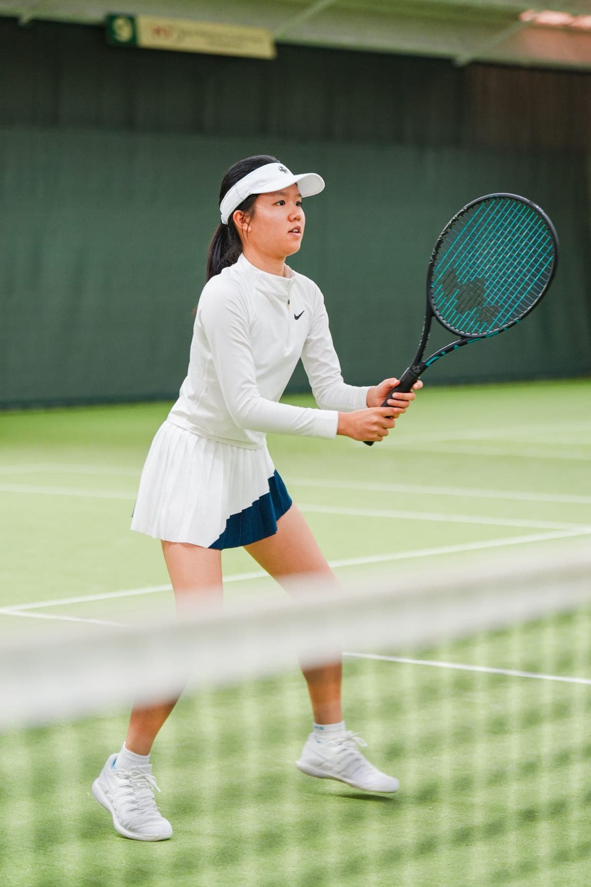 A player ready at the net with a Diadem racket