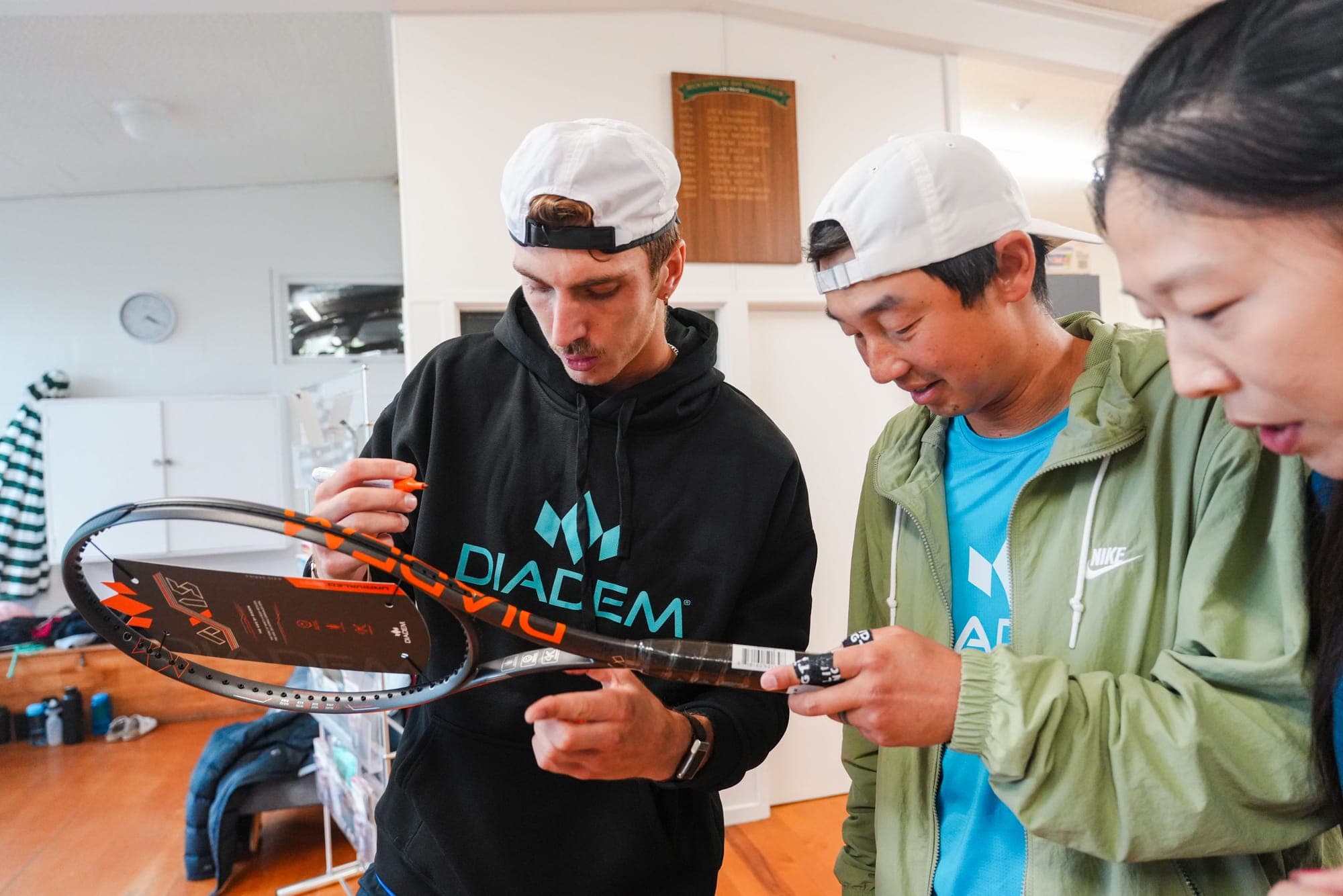 Anton signing a racket